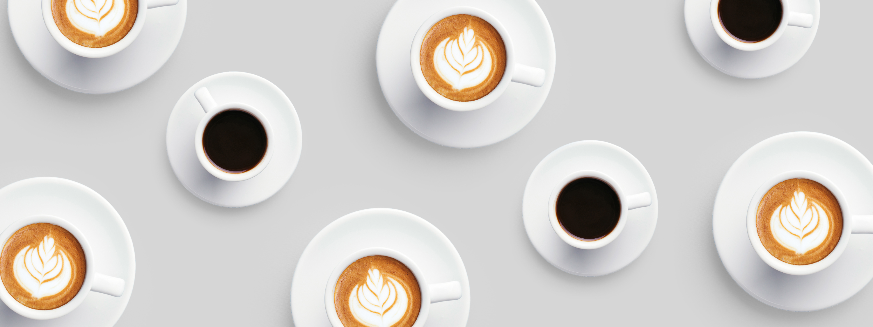 Beautiful coffee cups with latte art pattern